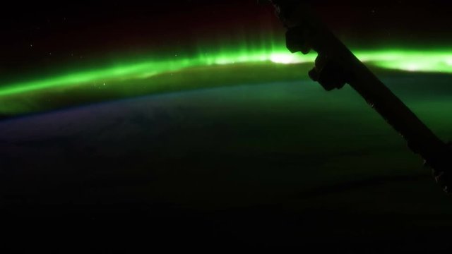 ISS (International Space Station) orbiting earth in 4k film resolution. Brilliant aurora (northern lights) can be seen below. Created with permission by NASA.  Public Domain images from Nasa that have