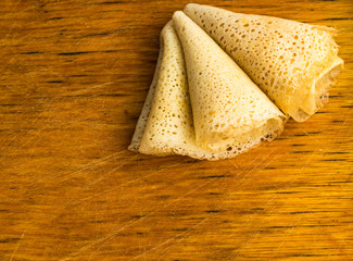 Thin Pancakes on a Wooden Background Top View