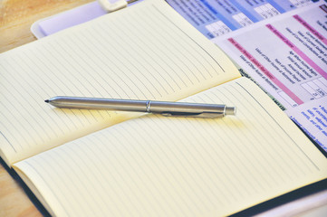 Top view business stuff with sale report, silver pen, notebook  business concept