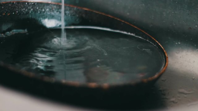 Dirty pan lies in the kitchen sink