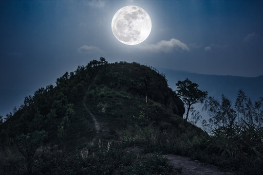 Mountain peaks landscape. Walkway to the top of a hill and full moon .