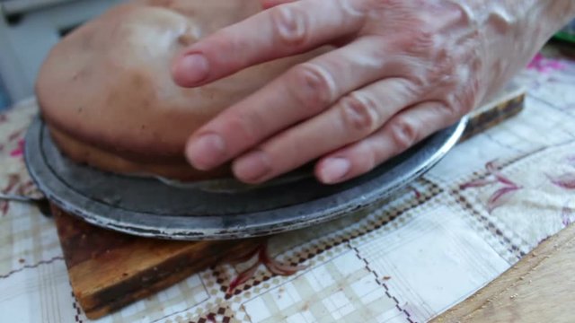 Woman with knife cuts the cake