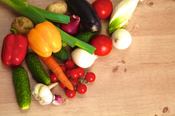 Pile of organic vegetables on a wooden table