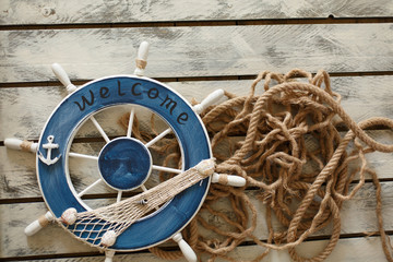 Steering wheel on old wood background. Skipper's wheel from an old ship.