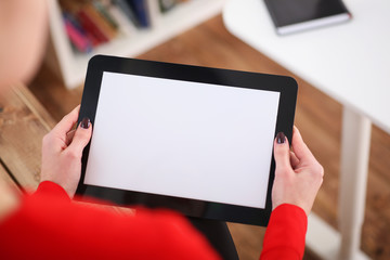 Woman holding tablet in hands. With depth of field image