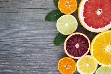 Obraz na płótnie Canvas Lemon,red orange, orange, grapefruit, lime, tangerine on old wooden table. Place for text. Background.