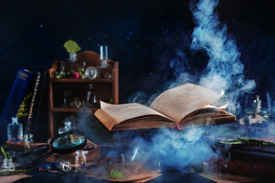 Aged book of magic open emitting magical sparks and smoke, evoking