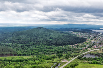 Fototapeta na wymiar Urban panorama aerial view. City surrounded by forest