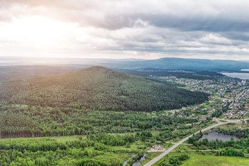 Urban panorama aerial view. City surrounded by forest