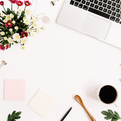 Top view home office table desk frame. Workspace with laptop, wildflowers bouquet, coffee cup, feminine accessories and office stuff. Flat lay.