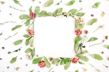 Round frame wreath pattern with roses, pink flower buds, branches and leaves on white background. Flat lay, top view. Flowers pattern