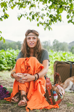 Hippie girl in headband and orange skirt