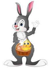 Easter bunny holding a basket with easter egg and chick