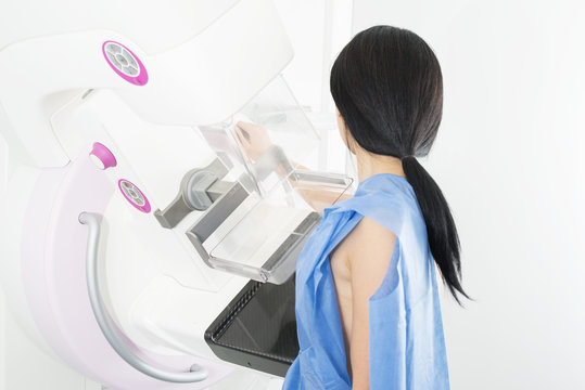 Side View Of Woman Undergoing Mammogram X-ray Test
