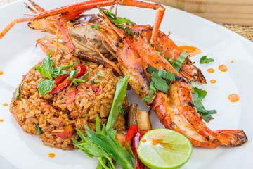Asian fried rice nasi goreng with chicken, prawns, egg and vegetables, Thai cuisine