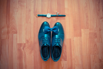 blue men's shoes and bow tie and wristwatch