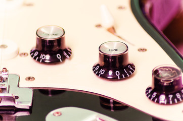 Knobs on an electric guitar, close up, selective focus