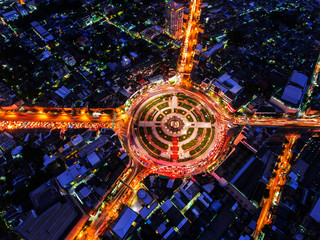 Road roundabout with car lots Wongwian Yai in Bangkok,Thailand.street large beautiful downtown at night.Aerial view cityscape.