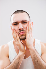 Young man is going to shave his beard.