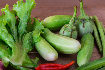 group of vegetable cucumbers,thai eggplants,long beens,Winged beans,lettuce,chilli,shallots,garlic.
