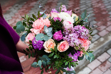 Woman holding beautiful bouquet of flowers