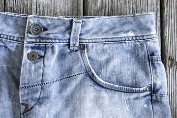 Blue jeans on wooden background