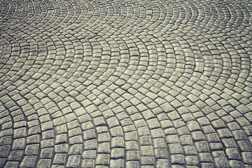 Vintage toned old cobblestone pavement background.