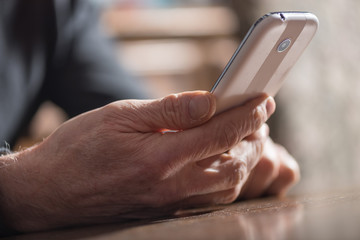 Hand holding a phone, hard light effect