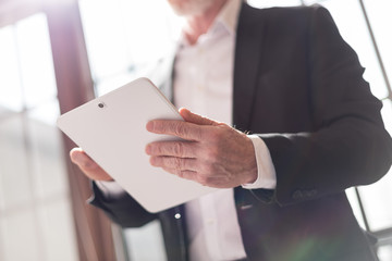 Businessman with tablet, light effect