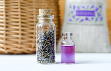 Two small bottles with dry lavender buds and essential aroma oil (perfume, tincture, infusion, extract). Aromatherapy and spa ingredients.