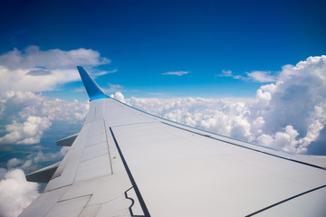 Wing of the plane on blue sky background