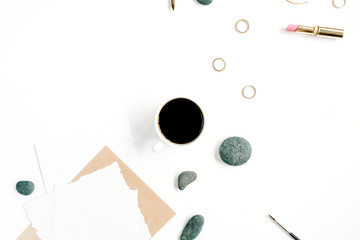 Top view office table desk. Workspace with coffee, craft envelope, stones, female accessories and paper blank on white background. Flat lay.