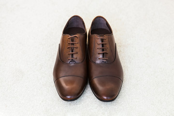Brown leather men's shoes. Groom accessories.