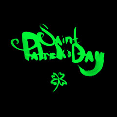 Hand drawn dry brush style phrase "Saint Patrick's day". Green letters on the black background.