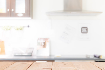 Wood table top (or kitchen island) on blur kitchen interior background