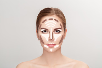 Contouring. Make up woman face on grey background.  Professional