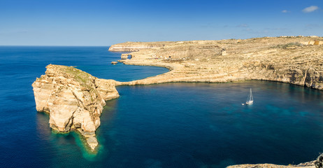 Gozo, Malta - Panoramic view of the beautiful Fungus rock with the Azure Window and sail boat at...