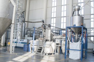 in the workshop machines for processing and manufacturing of plastic granules. a factory for processing plastic granules. PET