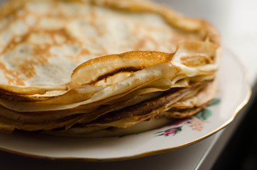 Pancakes or Russian Blintzes on white background. Selective focus.