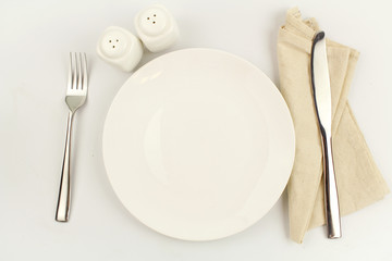 white plate on white background decoration with spoon and fork