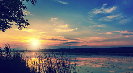 Sunset over the lake. colorful clouds in the sky, 