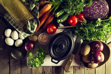 Cooking Healthy Vegetable Detox Concept with Various Vegetables, Cooking Pot on Kitchen Table, Kitchen Background. Top View with Copy Space.