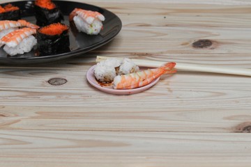Sushi Close up in black plate on wooden background, Asian food delicious