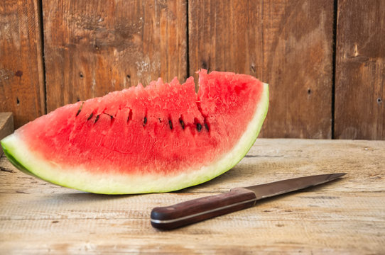 Slice of watermelon on a wooden background