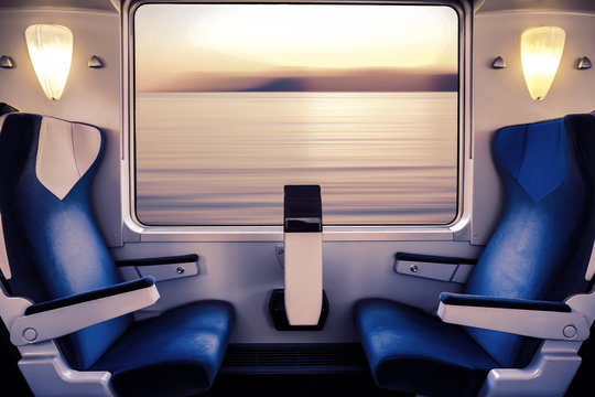 Fototapeta Empty seat in a train wagon overlooking the sea  