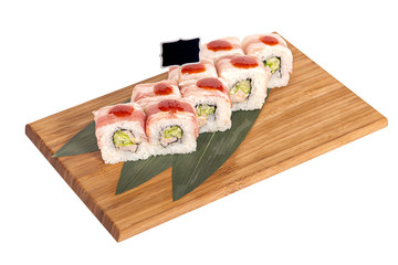 Sushi rolls on wooden Board with leaves of leeks and black sign for logo and name