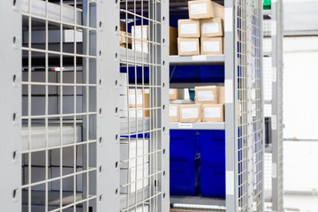 Storage bins and industrial storage racks in a warehouse shot with shallow focus