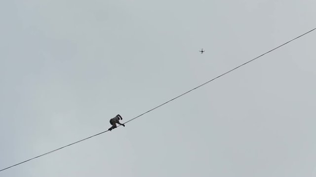 sleklayner balance between the buildings. Video shooting is underway with quadrocopters