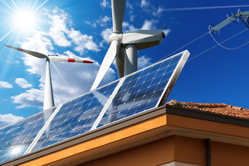 House roof with a solar panels, wind turbines and a power line