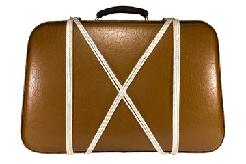 Isolated old suitcase from brown leather with black leather handle, tied with a white rope on a white background